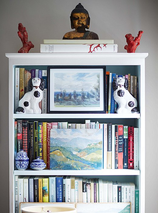 Placing art and collectibles in front of book spines can make a shelf look more cohesive (and can also obscure the titles of those guilty pleasures you might not want others to know you’ve read). Photo by Manuel Rodriguez.

